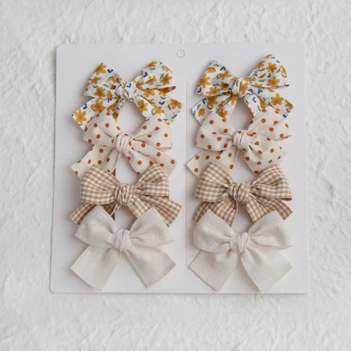 Élégants nœuds en tissu pour cheveux, clips modernes et adorables pour enfants. Ces accessoires couvrent bien les cheveux et sont confectionnés en tissu doux et tendance.